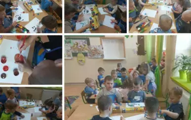 Dzieci z zaangażowaniem malowały farbami drewniane jajka.