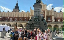 Zdjęcie grupowe uczni&oacute;w klas I&ndash;III przy pomniku Adama Mickiewicza w Krakowie
